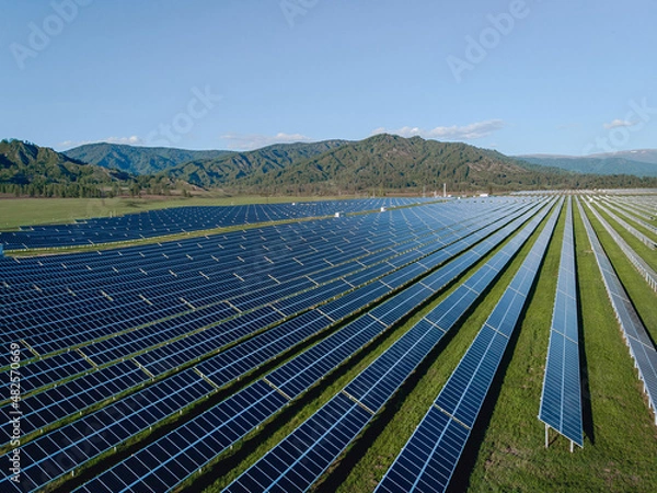 Fototapeta Technological innovations. A large number of solar panels standing in the mountains. Taking care of the environment.