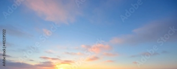 Obraz Clear blue sky with glowing pink and golden clouds after the storm. Dramatic sunset cloudscape. Concept art, meteorology, heaven, hope, peace. Graphic resources, picturesque panoramic scenery