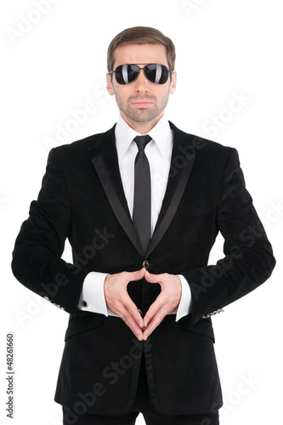 Fototapeta Stylish bodyguard with glasses and folded arms. Isolated