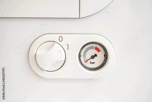 Obraz Indicators and key for the regulation of a gas boiler located on a wall.