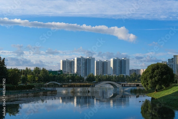 Fototapeta View of the city from the shore of the pond