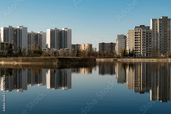 Fototapeta View of the city from the shore of the pond