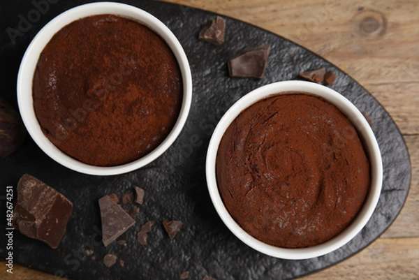 Fototapeta Delicious fresh fondant with chocolate chunks on wooden table, top view