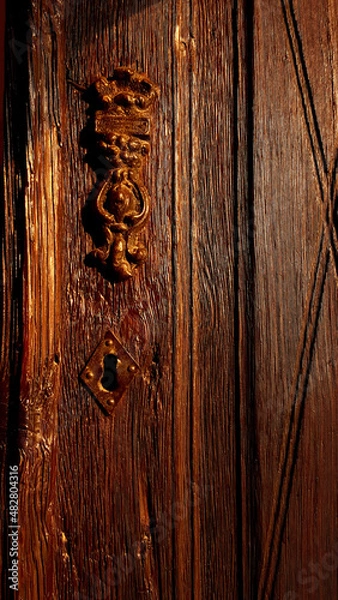 Fototapeta ancient wooden door with inverted keyhole and brass knocker located in the city of Tarsus Mersin province Turkey