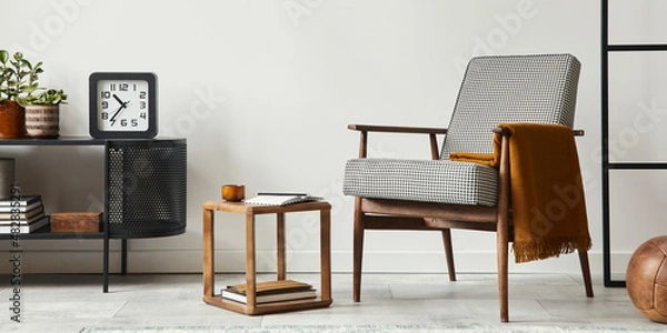 Fototapeta Stylish scandinavian composition of living room with design armchair, black mock up poster frame, commode, wooden stool, plant, decoration, loft wall and personal accessories in modern home decor.