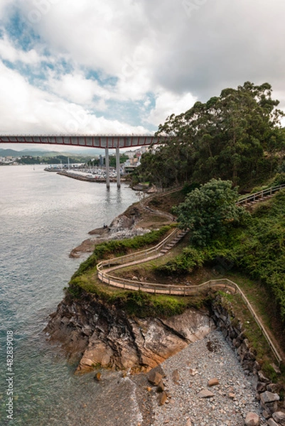Fototapeta Coastal path with bridge in the background