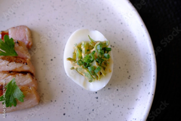 Obraz Marinated porks with Fish sauce and betel nut mix spicy sauce on the Egg
