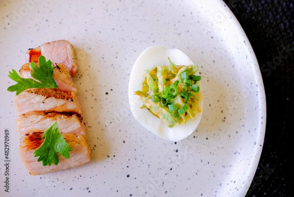 Obraz Marinated porks with Fish sauce and betel nut mix spicy sauce on the Egg
