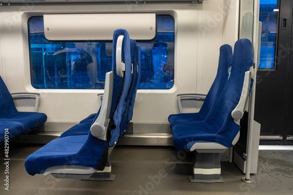 Obraz Modern train inside interior. Blue seats. Side view