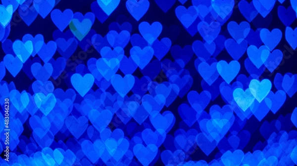 Obraz Bokeh background with blue hearts on black background. Love concept. Theme for Valentine's Day