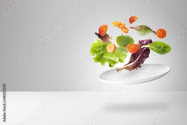 Obraz light salad with floating vegetables