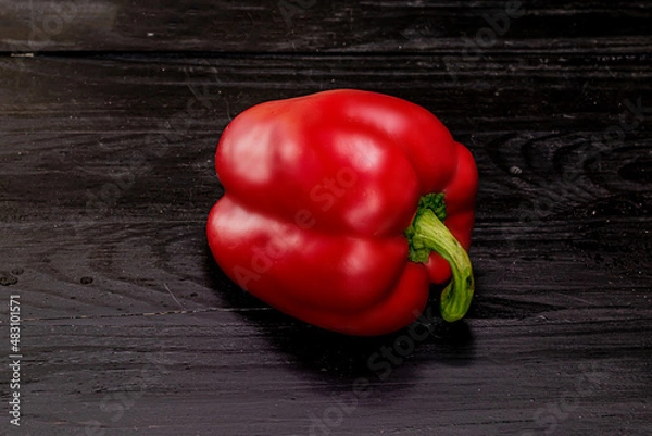 Obraz one red pepper on a black background
