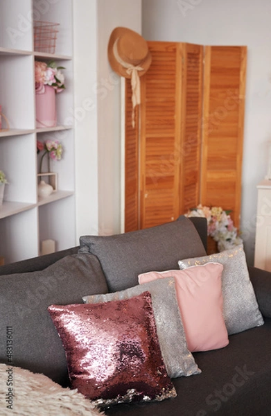 Fototapeta Pink living room. Studio apartment. Loft interior. Shelves and decor in room. Rent and delivery of housing. Hostel and hotel