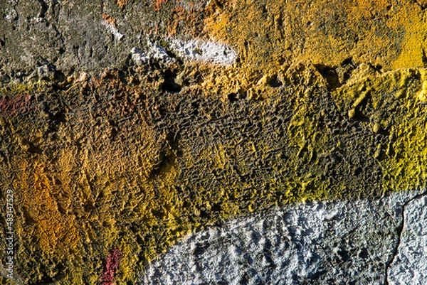 Fototapeta An old colorful concrete wall plastered with traces of old paint, texture.