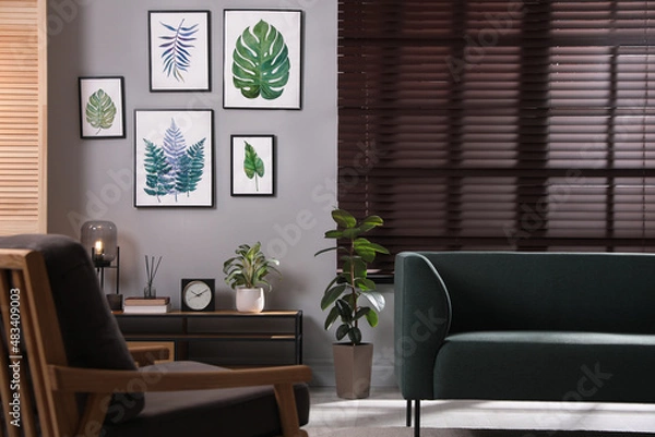Fototapeta Stylish living room interior with comfortable sofa and armchair