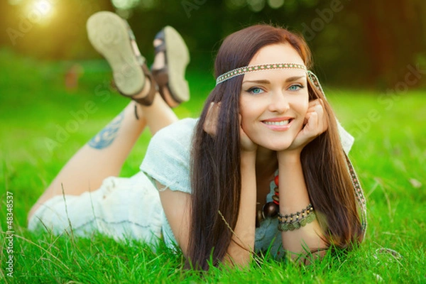 Obraz Smiling hippie girl on green grass