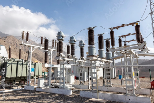 Fototapeta View of the electrical substation (electrical switchyard) for industrial mining plant on the mountain. A substation is a part of an electrical generation, transmission, and distribution system.