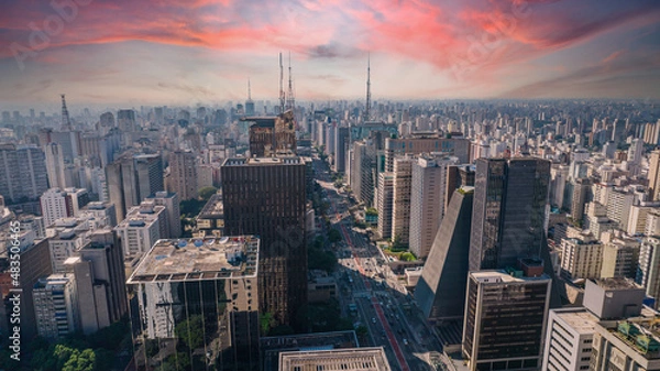 Fototapeta Aerial view of Av. Paulista in São Paulo, SP. Main avenue of the capital. With many radio antennas, commercial and residential buildings. Aerial view of the great city of São Paulo. Sunset