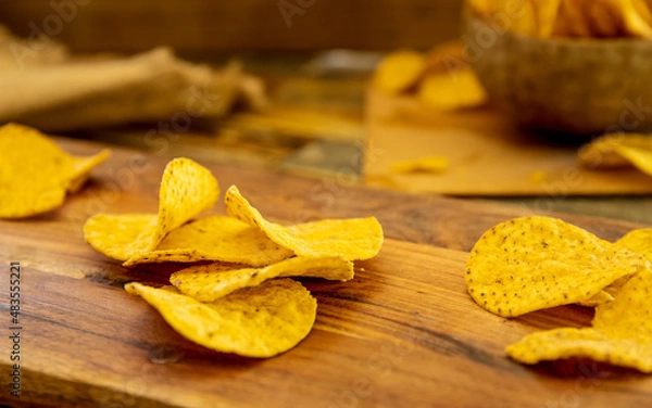Fototapeta potato chips and beer on wooden background in a cafe, pub or at home