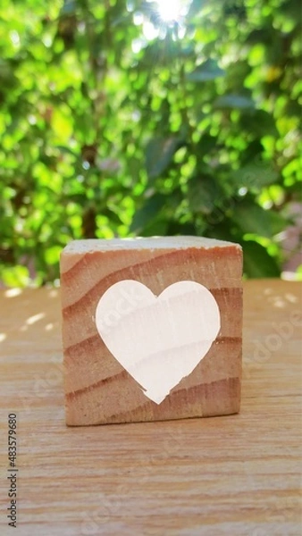 Fototapeta Conceptual of white heart. A heart shape in wooden cube