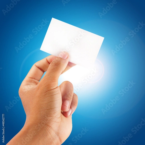 Fototapeta close up hand showing a blank card with blue sky background