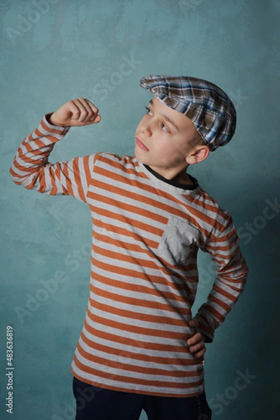 Obraz portret młodego chłopaka na tle niebieskiego muru 