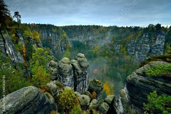 Obraz Saxon switzerland rathen bastei - rathener kessel - sandstone rock formations autumn forest clouds mist moody