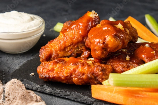 Obraz Appetizing buffalo chicken wings with vegetables. Selective focus. Close-up.