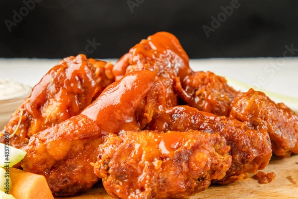 Obraz Lots of fried chicken wings covered in sauce. Buffalo wings.