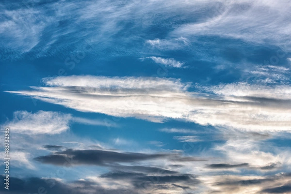 Fototapeta A bright sunset on the background of cloudy sky.