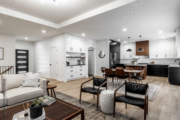 Fototapeta Midcentury modern kitchen with black and white cabinets, matte black fixtures, white quartz countertops and backsplash and walnut wood furniture interior design