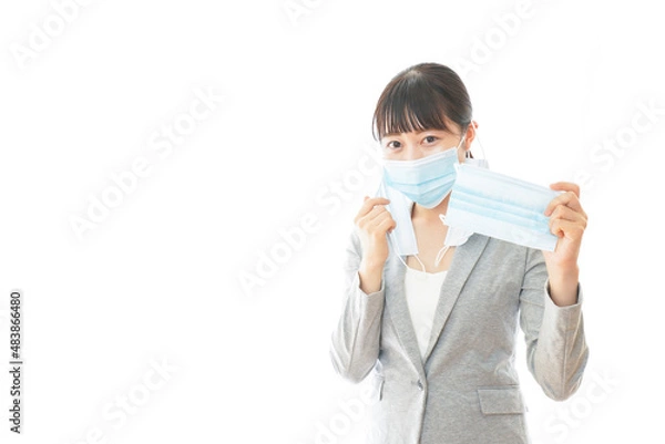 Fototapeta 大量のマスクを着けた若いビジネスパーソン