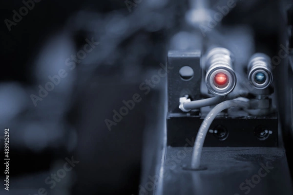 Fototapeta Photoelectric Sensor for distance detection in machine factory. Photo sensor installed in industrial machine. Industrial and Technology concept.