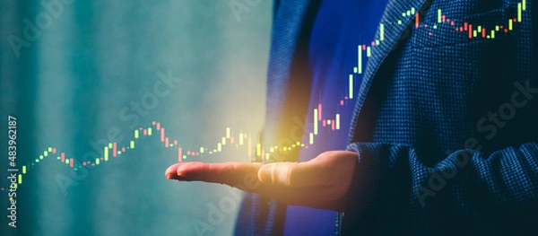 Fototapeta a successful investor, trader, manipulates the direction of the price of stocks, securities, the concept of investment and management, a close-up of the trader's hands