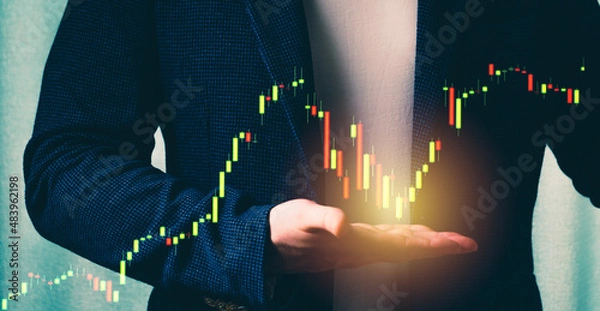 Fototapeta a successful investor, trader, manipulates the direction of the price of stocks, securities, the concept of investment and management, a close-up of the trader's hands