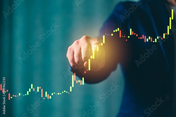 Fototapeta a successful investor, trader, manipulates the direction of the price of stocks, securities, the concept of investment and management, a close-up of the trader's hands