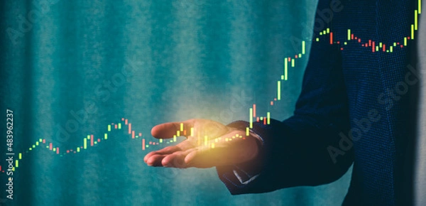 Fototapeta a successful investor, trader, manipulates the direction of the price of stocks, securities, the concept of investment and management, a close-up of the trader's hands