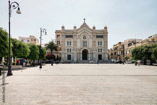 Fototapeta The cathedral in the historic city centre, where it shows its main façade on the wide Piazza. Reggio Calabria, Italy - July 2021