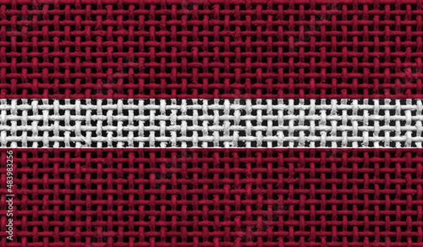 Fototapeta Latvia flag on the surface of a metal lattice. 3D image