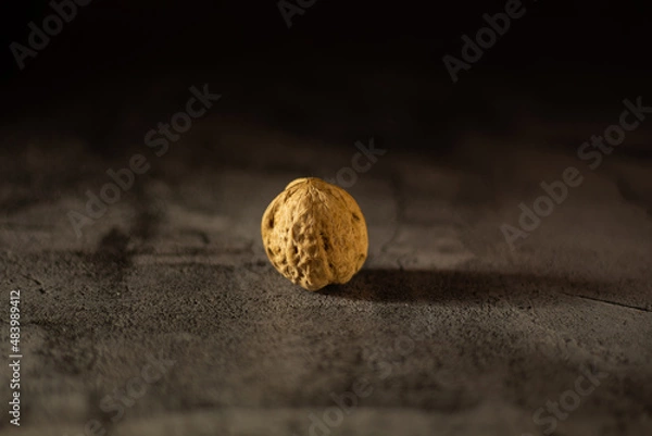 Obraz Walnuts on a dark background, One walnut