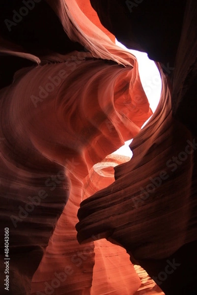 Fototapeta The contrast between the shadows and the lights inside the narrow red Antelope Canyon
