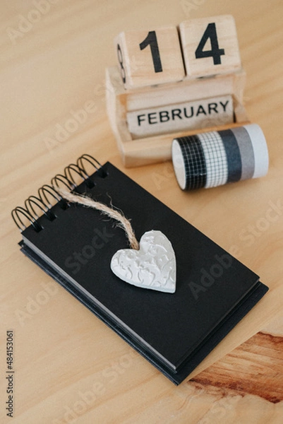 Fototapeta Wooden calendar on February 14 with a heart.