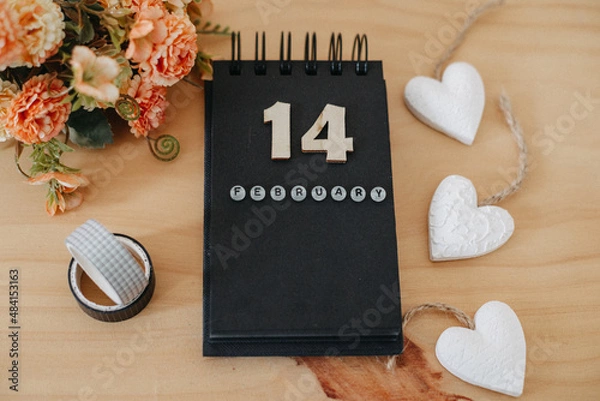 Fototapeta Wooden calendar on February 14 with roses and heart.