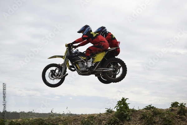 Obraz motocross bikers on motorcycles with carrycot