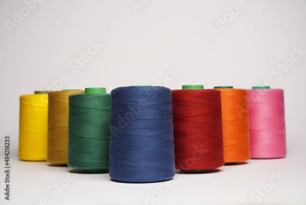 Fototapeta Colorful thread spool background, close-up