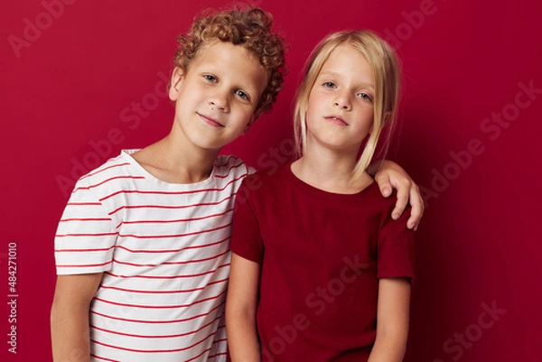 Fototapeta Portrait of cute children good mood standing next to posing on colored background