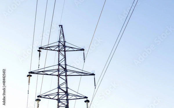 Fototapeta High voltage power lines, post or tower against the backdrop of a beautiful sky. Sequentially ordered high energy pylons.