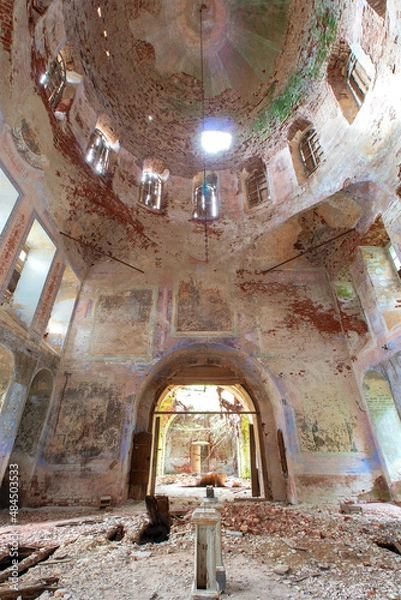 Fototapeta Exit from the middle part of the old destroyed Orthodox church in Russia. Exit in the center. Peeling paint and old red bricks. Symmetry. Daylight.