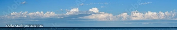 Fototapeta Panorama of sky with clouds over the sea horizon, nature background. Wide horizontal marine landscape with a beautiful sky for your weather banner or billboard.