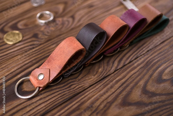Obraz Leather key rings on wooden background